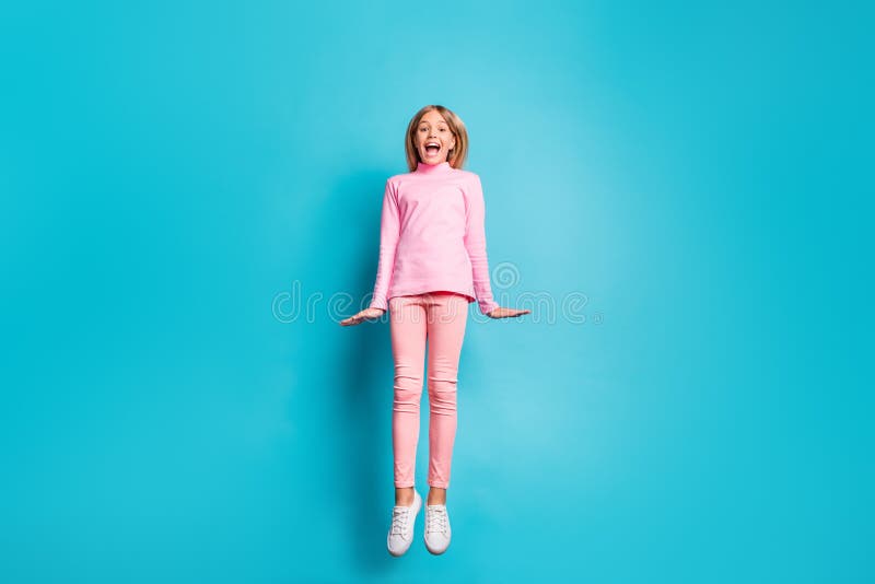 Full size photo of cool amazed nice teen girl jump air wear pink pants poloneck white footwear isolated on teal