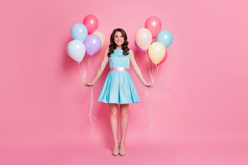 Full size photo of curly charming lady festive clothes event prom party, hold both hands many air balloons wear blue teal mini dress skirt high-heels isolated pastel pink color background. Full size photo of curly charming lady festive clothes event prom party, hold both hands many air balloons wear blue teal mini dress skirt high-heels isolated pastel pink color background