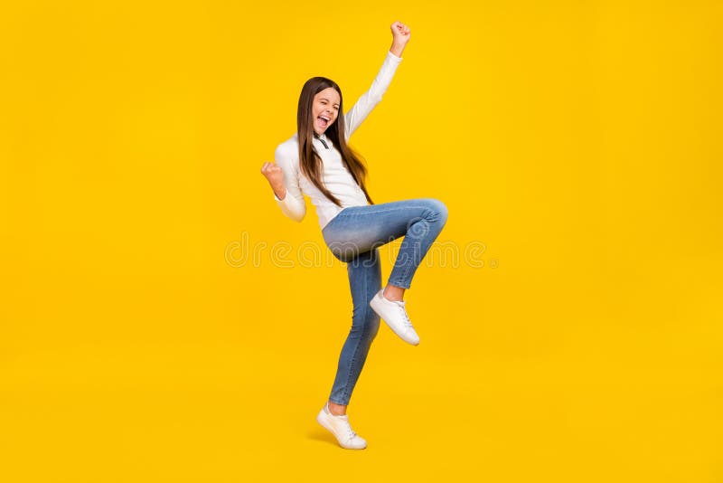 Full size photo of hooray brunette teen girl yell wear white pullover jeans sneakers  on yellow color background