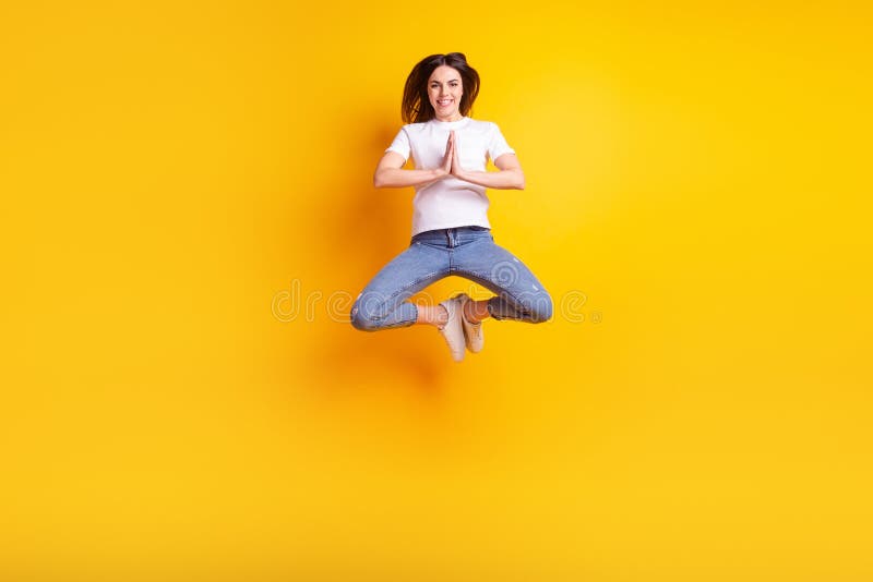 Full size photo of young attractive pretty girl jumper anticipation isolated over yellow color background royalty free stock images