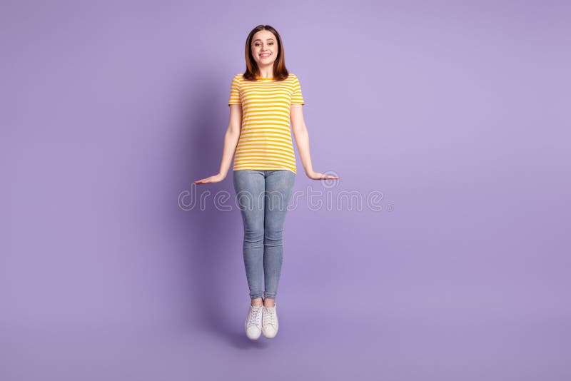 Full size photo of young lovely girl jump up have fun air fly wear casual clothes isolated over purple color background