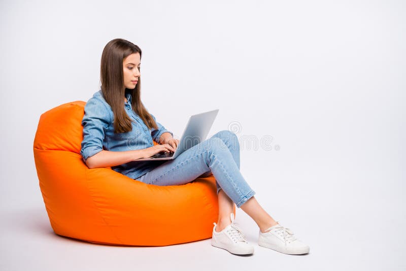 Full size profile side photo of serious concentrated girl work on her computer chat with start-up clients sit big bag