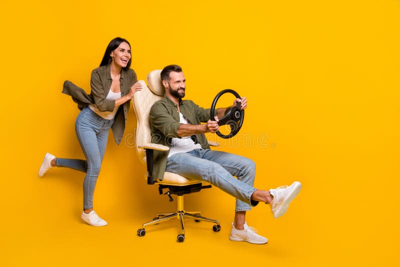 Full size profile side photo of young girl guy sit stool play videogame fast speed transport isolated over yellow color