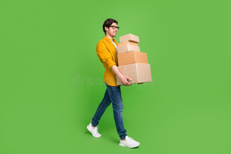 Full size profile side photo of young handsome positive man go walk moving new home isolated on green color background.