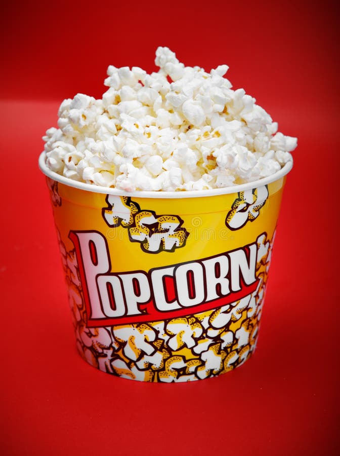 Full Yellow Bucket of Popcorn on Red Background Stock Photo Image of