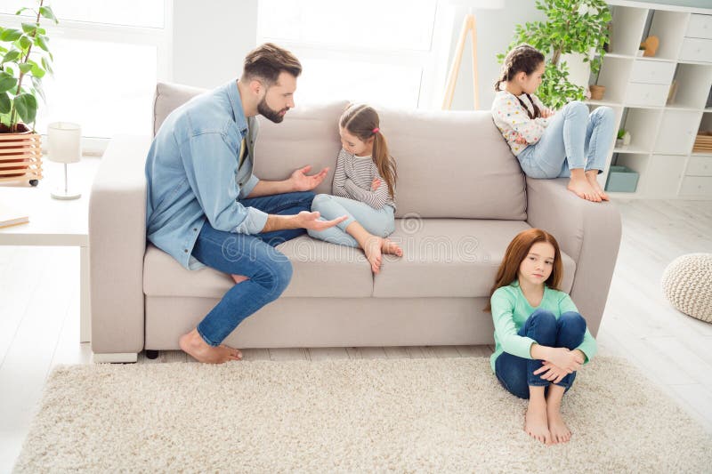 Full size portrait of four persons handsome men speak hands explaining to daughters warn about bad behavior indoors. Full size portrait of four persons handsome men speak hands explaining to daughters warn about bad behavior indoors.