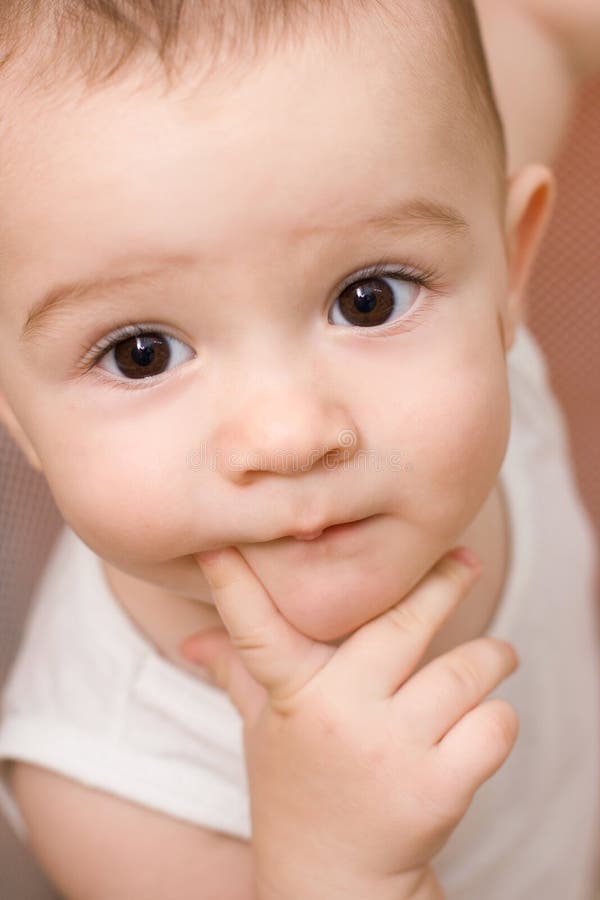 Fun Caucasian Baby With Finger In His Mouth Stock Photo - Image of