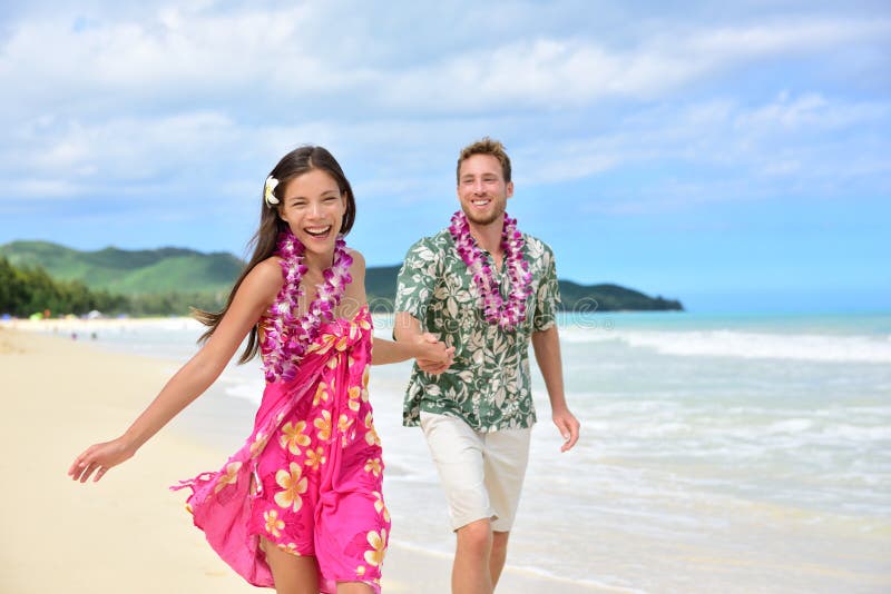 Fun couple on beach vacations in Hawaiian clothing