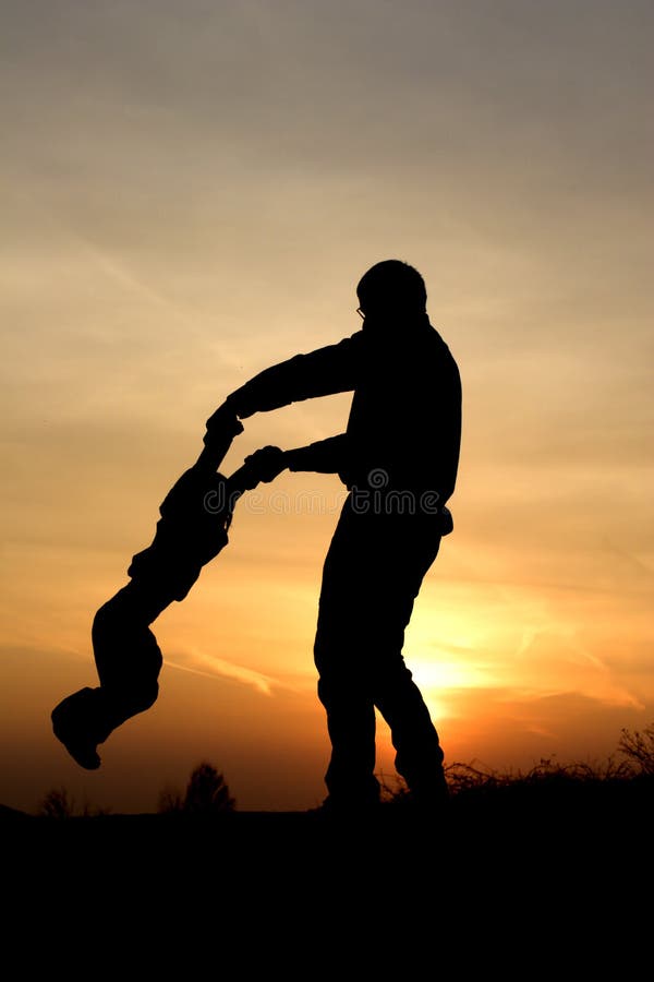 Fun of father and child in sunset stock photo