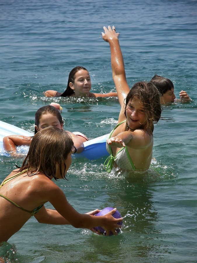 Children (best friends) have fun and play games on Adriatic sea in Croatia. Vertical color photo. Children (best friends) have fun and play games on Adriatic sea in Croatia. Vertical color photo.