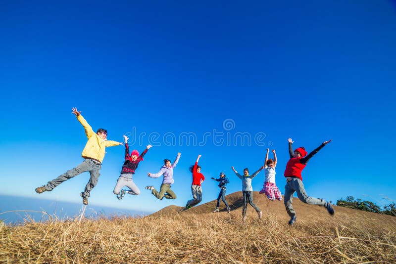 Fun Group of Young People Jumping Outdoors