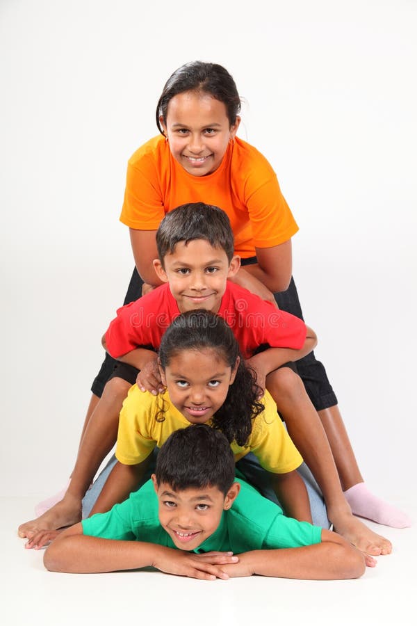 Fun human totem pole by four young school friends