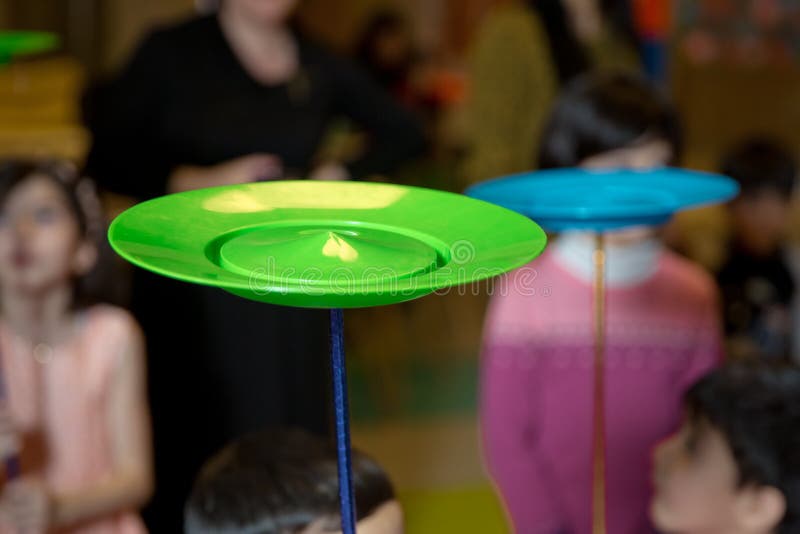 Fun with Spinning Plates .balancing a Spinning Plate. a Collection of Spinning Yellow, Blue, Red