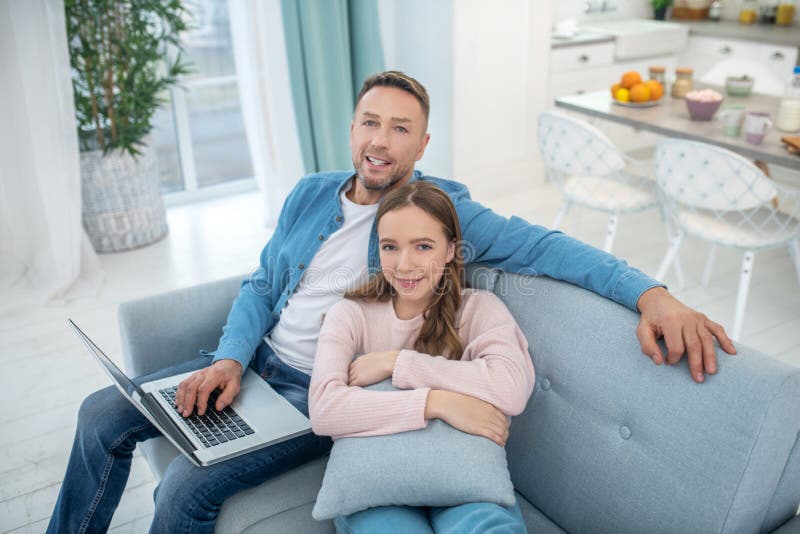 Happy Daughter and Dad with Laptop Sitting at Home on Couch. Stock ...