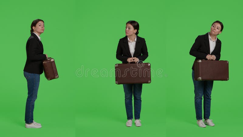 Office employee carrying vintage suitcase wearing corporate suit, holding briefcase or travel bags over full body greenscreen backdrop. Company worker with baggage preparing to leave. Office employee carrying vintage suitcase wearing corporate suit, holding briefcase or travel bags over full body greenscreen backdrop. Company worker with baggage preparing to leave.