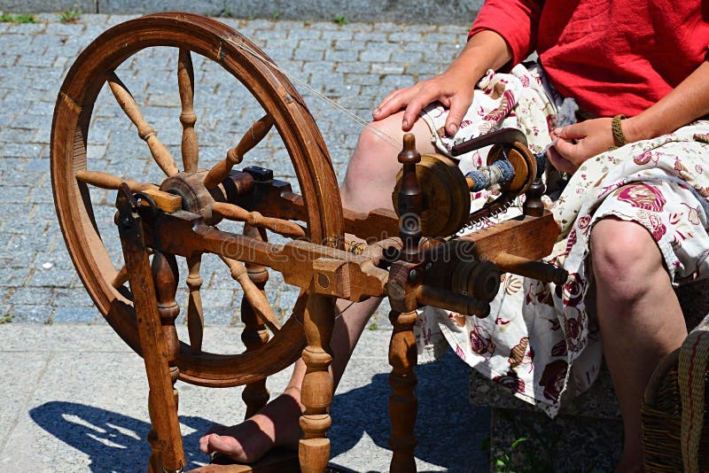 Functional historical spinning wheel used for thread making deemonstrated on festival of medieval and traditional crafts