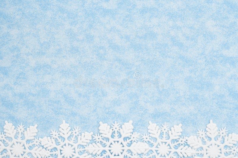 White and blue snowflake background with copy space for winter or holiday backgrounds. White and blue snowflake background with copy space for winter or holiday backgrounds