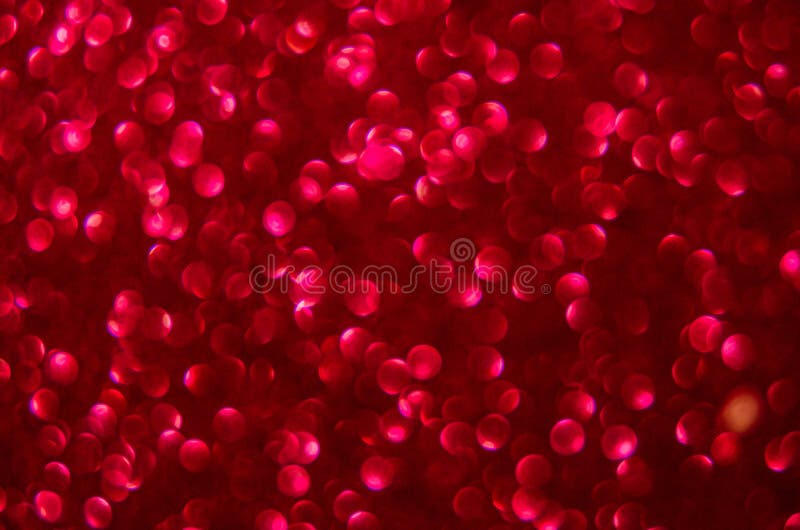 Defocused abstract red glitter background. Sequins on paper. Defocused abstract red glitter background. Sequins on paper