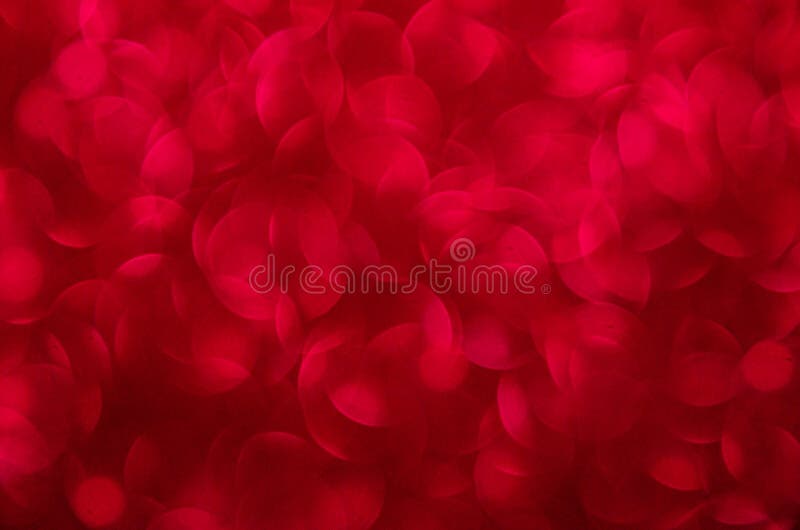 Defocused abstract red glitter background. Sequins on paper. Defocused abstract red glitter background. Sequins on paper