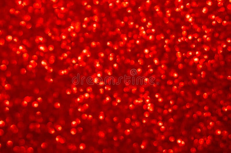 Defocused abstract red glitter background. Sequins on paper. Defocused abstract red glitter background. Sequins on paper