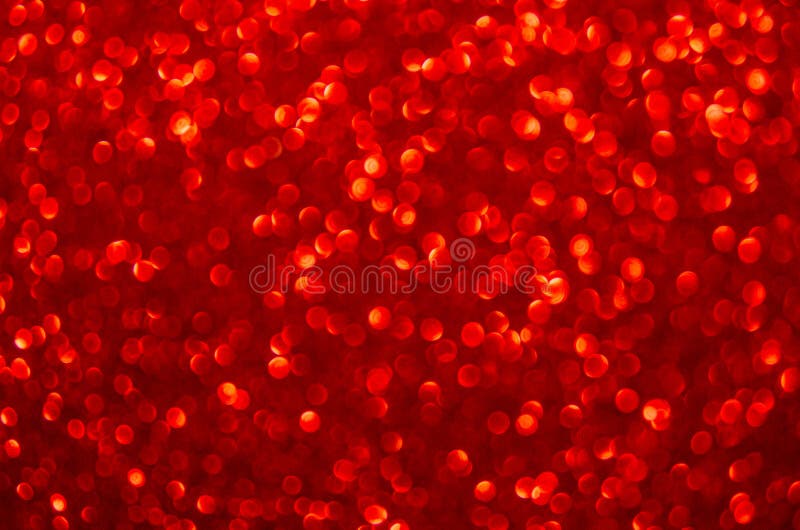 Defocused abstract red glitter background. Sequins on paper. Defocused abstract red glitter background. Sequins on paper