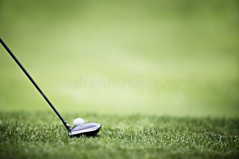 Golf ball behind driver at driving range, plenty of copy-space and very shallow depth of field. Golf ball behind driver at driving range, plenty of copy-space and very shallow depth of field.