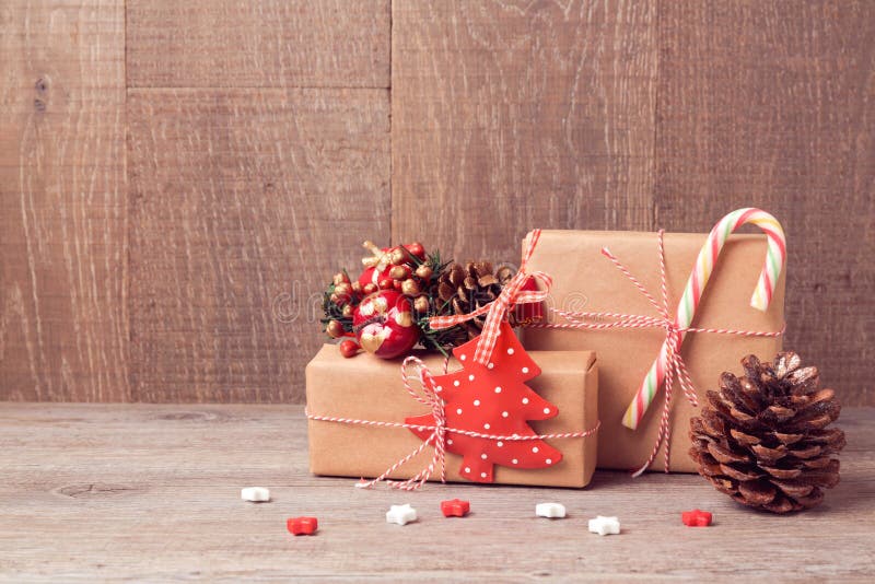 Fundo do Natal com caixas de presente e as decorações rústicas na tabela de madeira