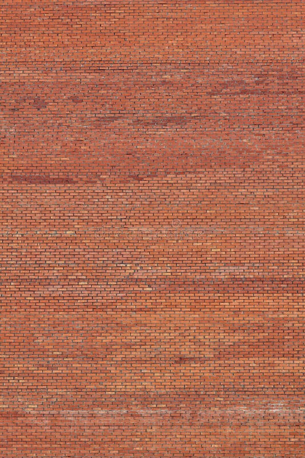 Fundo do vertical da parede de pedra de tijolo vermelho