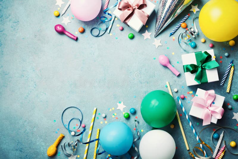 Funny birthday party background. Colorful balloon, gift box, confetti, candy and streamer on turquoise table top view. Flat lay style. Copy space for greeting. Funny birthday party background. Colorful balloon, gift box, confetti, candy and streamer on turquoise table top view. Flat lay style. Copy space for greeting.