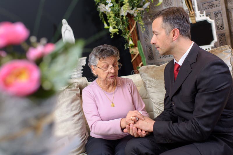 Funeral director comforting woman