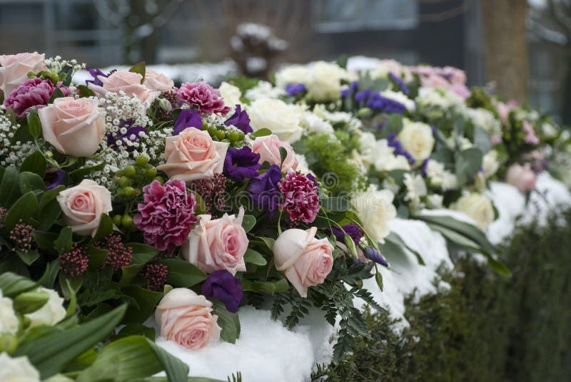 Funeral flowers arrangement in the snow on a cemetery
