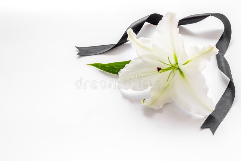 Funeral Lily Flowers with Cross on Dark Stone Background. Mourning ...