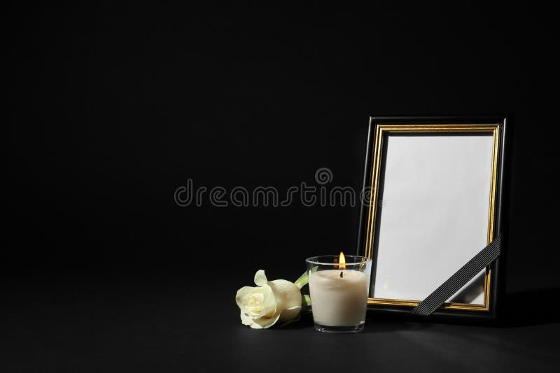 Funeral photo frame with ribbon, white rose and candle on background. Space for design