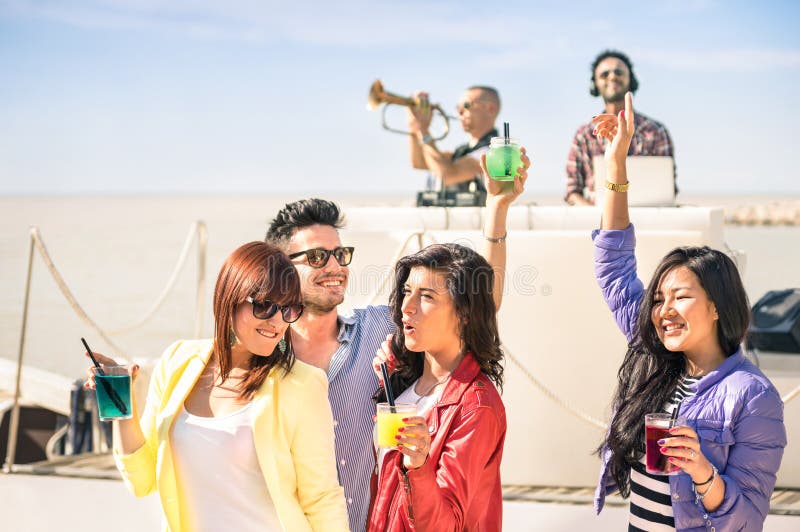 Funky people dancing music and having fun together at beach rave stock image Funky people dancing music and having fun together at beach rave stock image