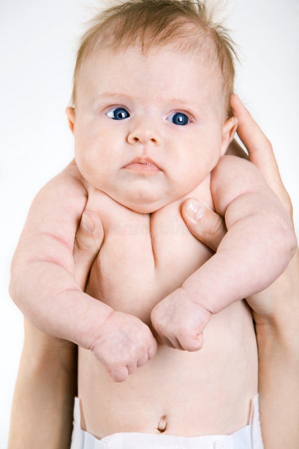 Funny baby. Photo of female hands holding the funny baby with blue eyes stock images Funny baby. Photo of female hands holding the funny baby with blue eyes stock images