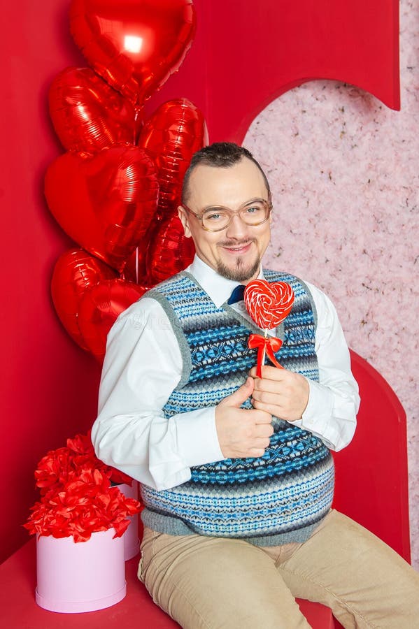 Funny Bearded Retro Style Man In The Blue Vest Holding Red Heart Shape Lollipop Stock Image