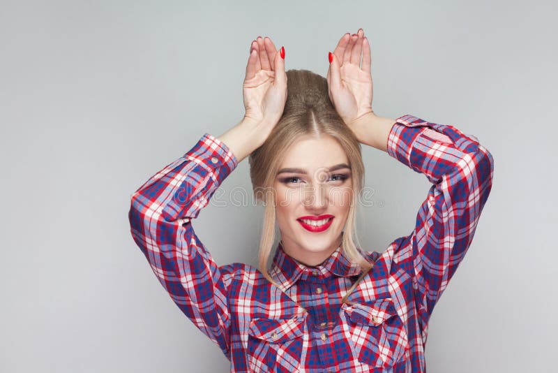 Funny beautiful blonde girl with pink checkered shirt, collected royalty free stock photo Funny beautiful blonde girl with pink checkered shirt, collected royalty free stock photo