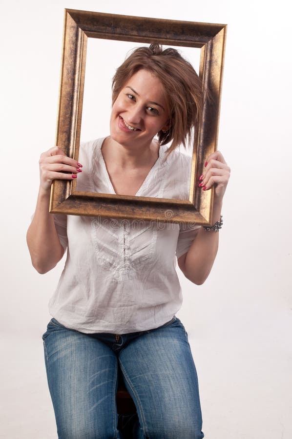 Funny Beautiful Woman Holding Around Her Face a Frame Stock Photo