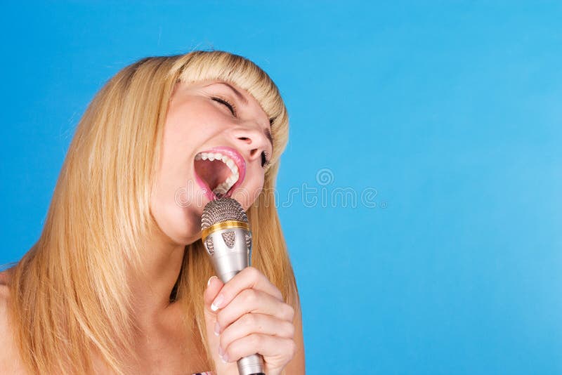 Funny blonde on a blue with a microphone