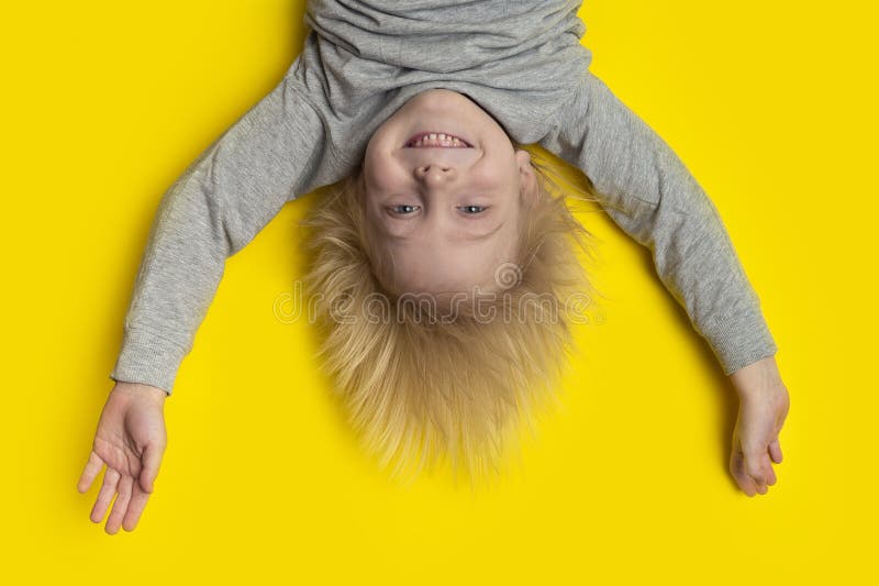 Funny Boy with Blond Hair Hanging Upside Down. Yellow Background Stock Photo - Image of funny, happy: 188298888 Funny Boy with Blond Hair Hanging Upside Down. Yellow Background Stock Photo - Image of funny, happy: 188298888