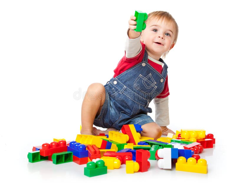 A funny boy is playing with lego