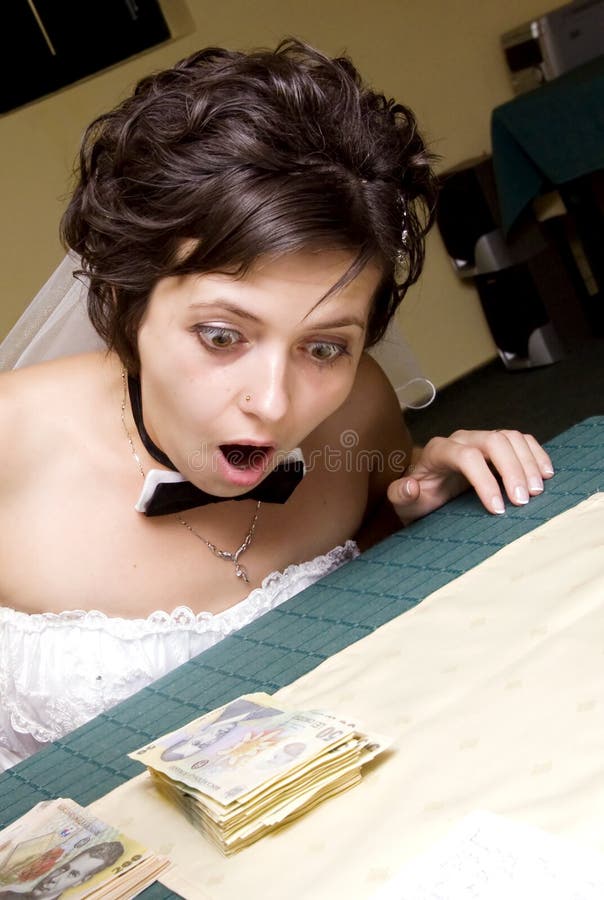 Funny bride looking at stack of mo