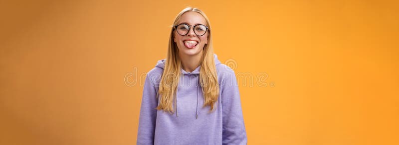 Funny charming female programmer having fun show tongue fool around coworkers during lunch break smiling broadly stock photography
