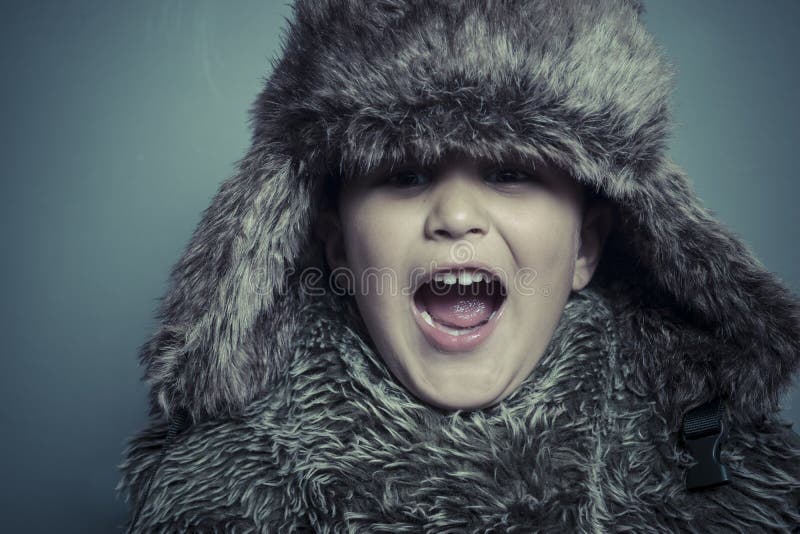 Funny Child with Fur Hat and Winter Coat, Cold Concept and Storm Stock