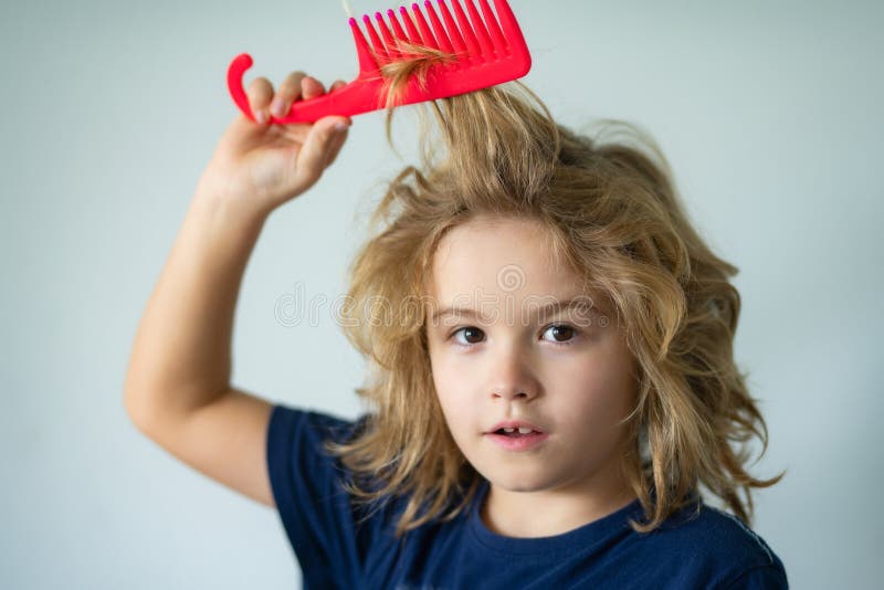 Funny child hairstyle. Child with a comb and problem hair. Kids shampoo. Hair does not comb without a conditioner balm. stock image
