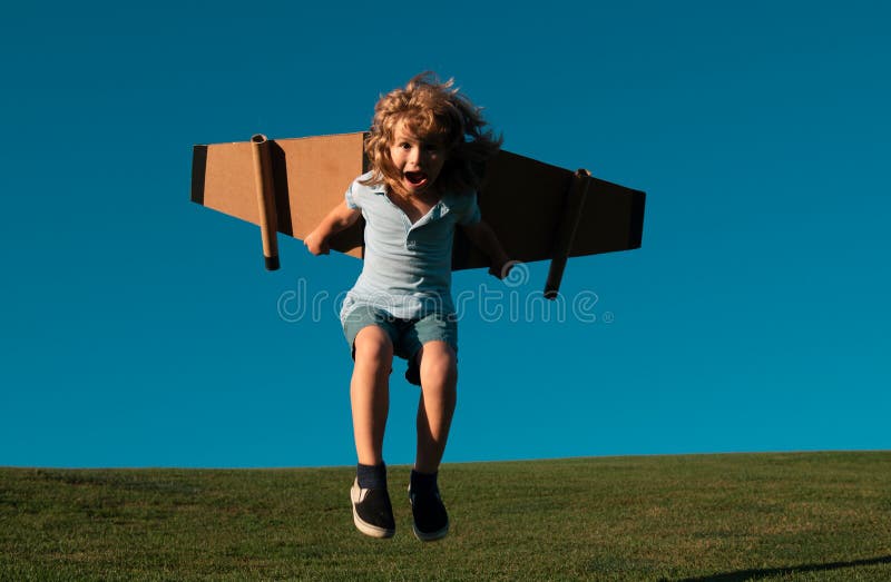 Funny Child jumping and running with toy jetpack. Child pilot astronaut or spaceman dreams of flight. Aviator boy flying royalty free stock photos