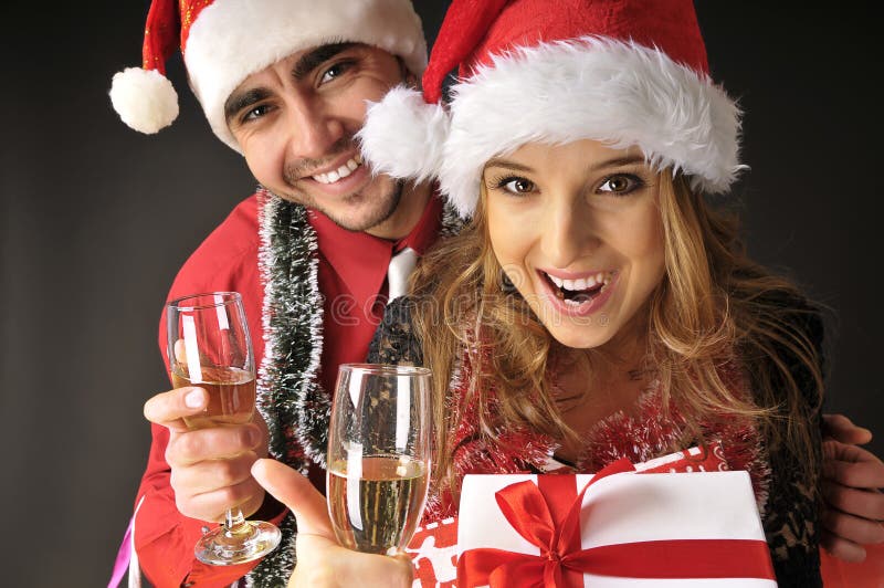 Funny Christmas couple with glasses of champagne.