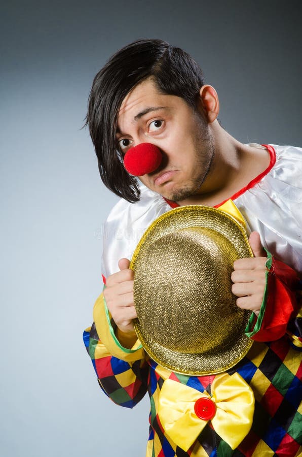 Funny clown against dark background royalty free stock photography