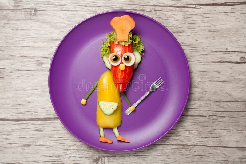 Funny cook with fork made of vegetables on plate royalty free stock photo Funny cook with fork made of vegetables on plate royalty free stock photo