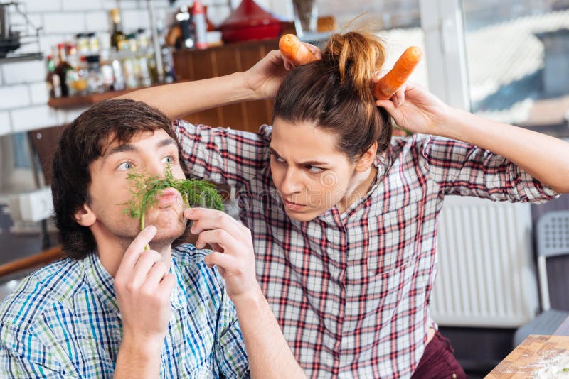Funny couple cooking and having fun together on kitchen stock image